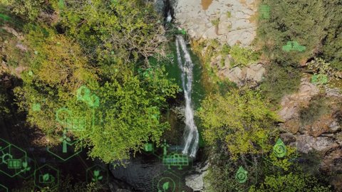 Beautiful waterfall on green mossy rocks. Water stream flowing in rocky path among wild forest. Wild mountain waterfall landscape. Wild waterfall rocks