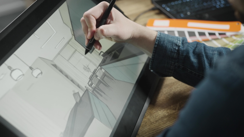 An experienced interior designer creates a digital sketch of a modern kitchen. A professional works with a digital graphics tablet. | Shutterstock HD Video #1090493777