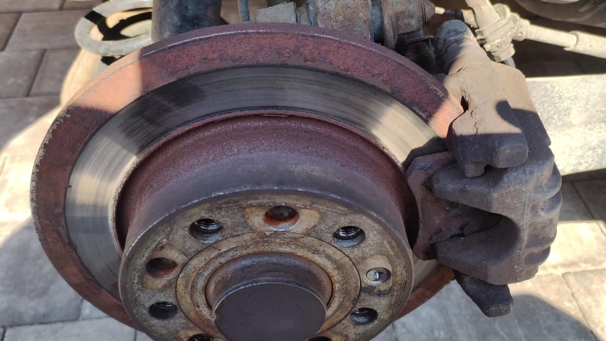 Used brake disc. Car brake repair, workshop concept