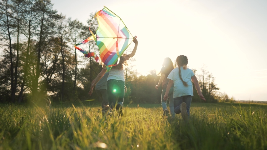 Happy family in park with dog run kite. Family picnic on green grass with pet. People play with kite in meadow in summer. Children with parents freedom and active lifestyle Family in nature dog play | Shutterstock HD Video #1090499047