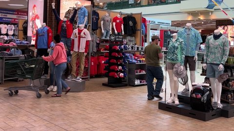 Springfield, IL USA - May 2, 2022: Panning up on a display of St. Louis Cardinals and Chicago Cubs baseball clothing for sale at the Scheels Sporting Goods store in Springfield, Illinois.