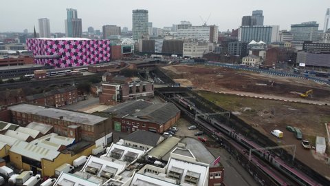BIRMINGHAM, UK - 2022: Misty aerial view of Birmingham UK with passing trains the city