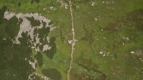 Aerial view of group people hiking along trail path. 4k video footage