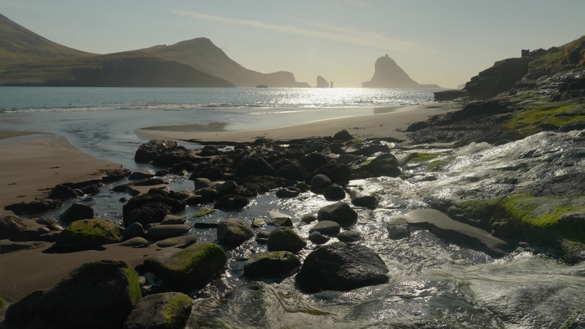 Tindholmur Islet And Drangarnir Sea Stacks Seen From The Stream In Bour, Vagar, Faroe Islands. - wide shot