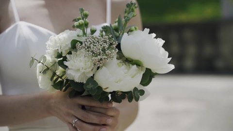bride holding bouquet of white flowers
