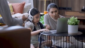 study online together Asian mother and daughter watching online course lesson at home while school closed during coronavirus outbreak and classes have moved to e-learning platform,home online study 