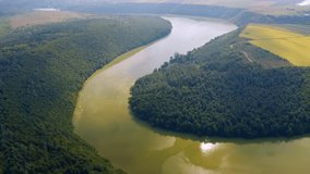 Fantastic scene of a large river flowing across the plain. Footage from a bird's eye view. Location place Seret canyon, Ukraine, Europe. Cinematic drone shot. Filmed in UHD 4k video. Beauty of earth.