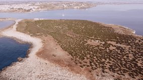 Aerial drone video. Footage of the rocky coastline and island at Portopalo di Capo Passero, Siracusa Province, Sicily.
