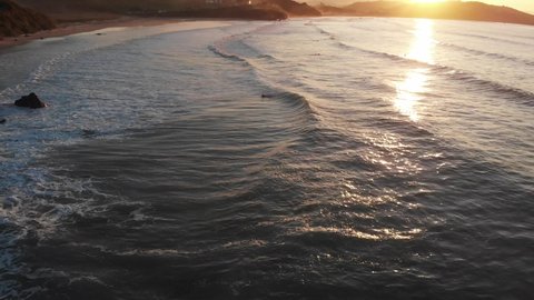 The beautiful footage of the gentle waves at sunset  Playa de Gerra, Cantabria, Spain 
