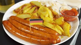Plate with tasty sausages, sauce and flag of Germany. German national food. - Powered by Shutterstock - Get 15% off with code: PIKWIZARD15