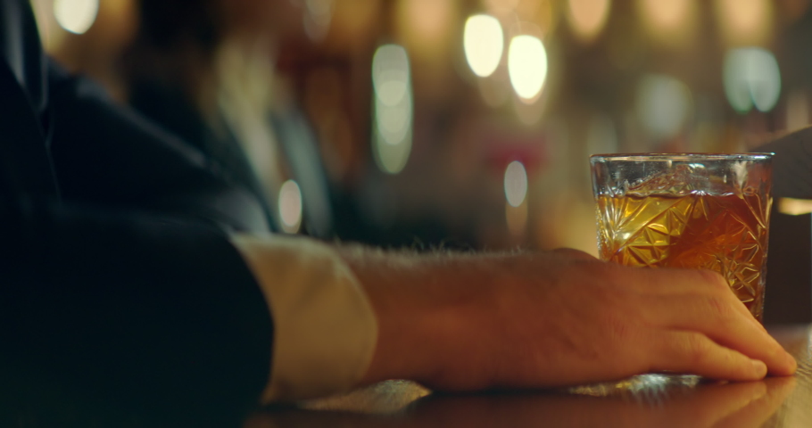 CU Portrait of handsome 30s adult Caucasian male enjoying a drink at the bar or restaurant in the evening. Shot with 2x anamorphic lens Royalty-Free Stock Footage #1090510707