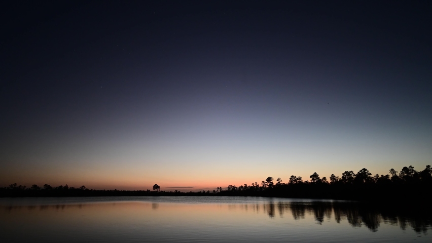 Twilight timelapse over Pine Glades Lake in Everglades National Park, Florida on clear starry evening 4K.