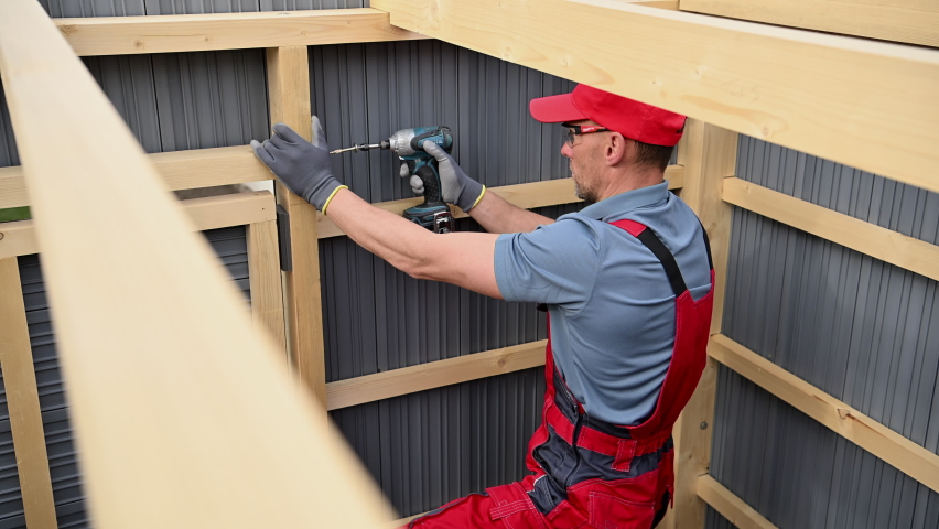 Wood Skeleton Frame and Composite Walls Garden Storage Shed Building by Caucasian Professional Shed Builder. Backyard Garden Tools Storage.