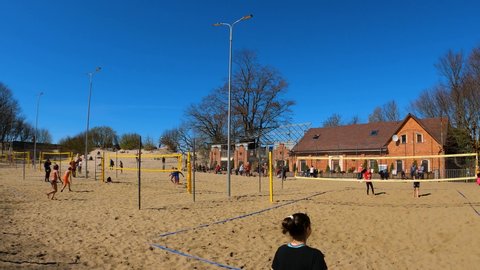 Kaliningrad, Russia, 14, May, 2022:
Volleyball courts on the sandy beach, many players play outdoor volleyball in the spring on the beach
