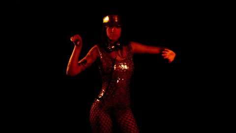 A beautiful female disco dancer in gold costume