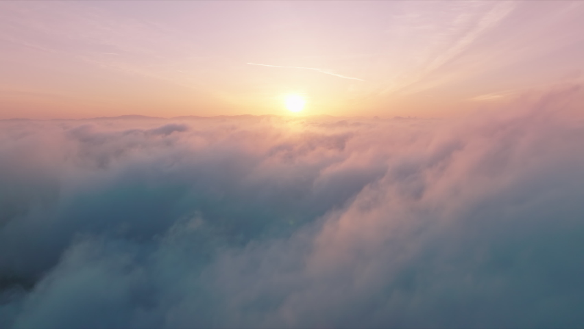 Flying through cinematic rose golden glowing cloudscape towards sunset sun. Flying in soft clouds. Aerial perspective view of flying over clouds. Sky with clouds and sun. Meditation dream footage 4K  Royalty-Free Stock Footage #1090515305