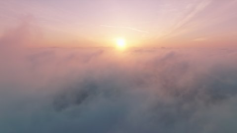 Flying through cinematic rose golden glowing cloudscape towards sunset sun. Flying in soft clouds. Aerial perspective view of flying over clouds. Sky with clouds and sun. Meditation dream footage 4K  库存视频