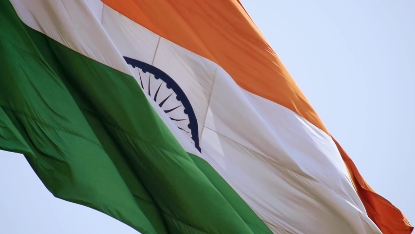 India flag flying high at Connaught Place with pride in blue sky, India flag fluttering, Indian Flag on Independence Day and Republic Day of India, tilt up shot, waving Indian flag, Flying India flags Royalty-Free Stock Footage #1090518119