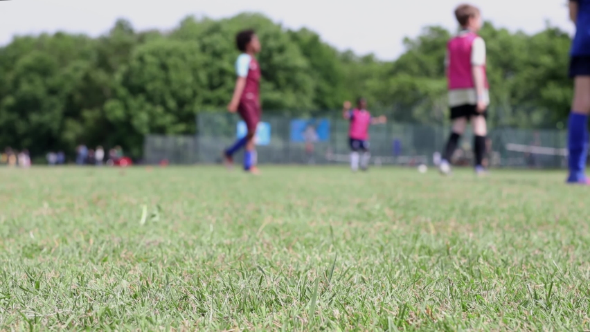 Children playing football - shallow focus.  Real time Royalty-Free Stock Footage #1090519159