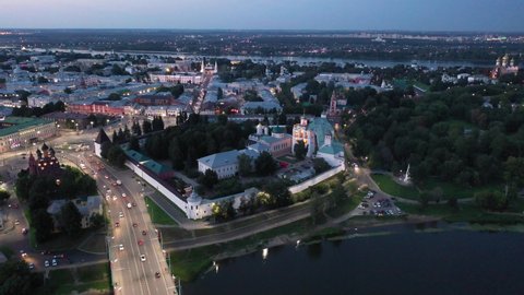 Scenic aerial view of Yaroslavl cityscape on banks of Volga River overlooking architectural complex of Transfiguration monastery in summer twilight, Russia