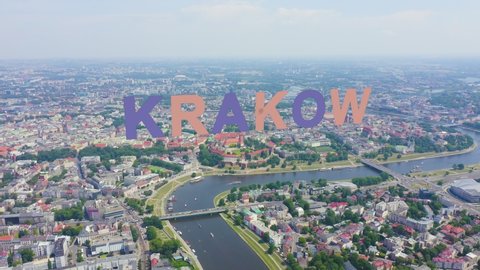 Inscription on video. Krakow, Poland. Wawel Castle. Ships on the Vistula River. View of the historic center. Multicolored text appears and disappears, Aerial View