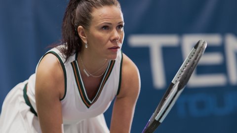 Potrait of Female Tennis Player Holding the Racquet During Championship Match, Ready for Receive Ball Strike. Professional Woman Athlete. Sports Broadcasting on TV Channel. Dramatic Slow Motion