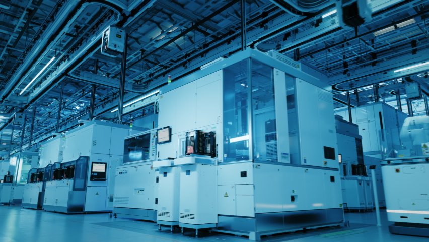 Wide Shot Inside Advanced Semiconductor Production Factory Cleanroom. Automated Robots are Transporting Wafers between Machines. Royalty-Free Stock Footage #1090523133