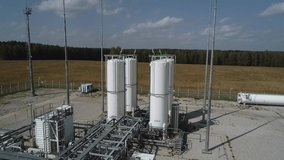 The drone rises above the storage tanks for gaseous substances. Industrial tanks of an air separation plant, vertical separators for cleaning compressed air and gas