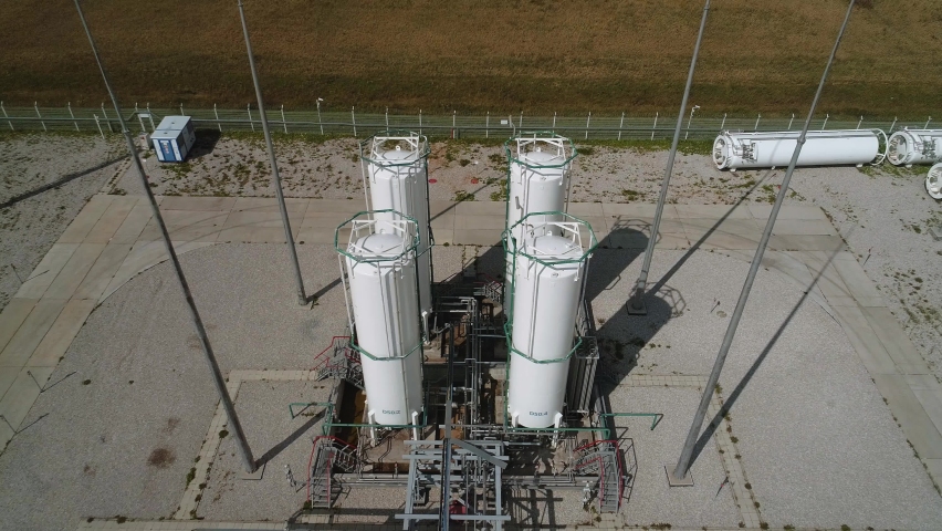 Close-up of vertical separators for cleaning compressed air and gas. The drone flies up to the storage tanks for gaseous substances. Industrial tanks of air separation plant