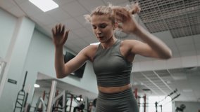 Woman exercising jumps on floor in the gym. Shot with RED helium camera in 8K. 