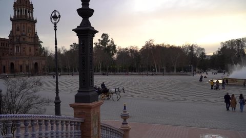 Seville , Spain - 02 24 2022: Slow motion pan across Plaza de Espana in Seville, Spain with horse carriage