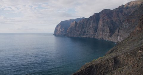Los Gigantes steep huge cliffs rock wall bordering the blue atlantic ocean seascape. Tenerife, Spain, Canary islands, europe.