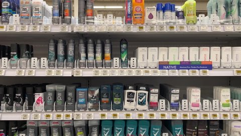 Edmonton, Canada - May 12, 2022: Various roll-on and spray deodorant for sale on a pharmacy shelf