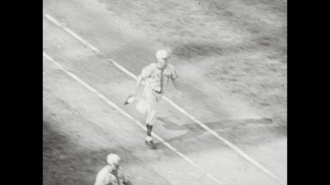 1940s: George McQuinn comes up to bat against Mort Cooper, hits home run; smiling manager waves in runner.