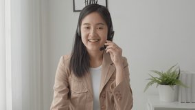 Young asian businesswoman wearing headset video call and presentation for conference online at home, woman meeting and talking for present, one person, business and communication concept.