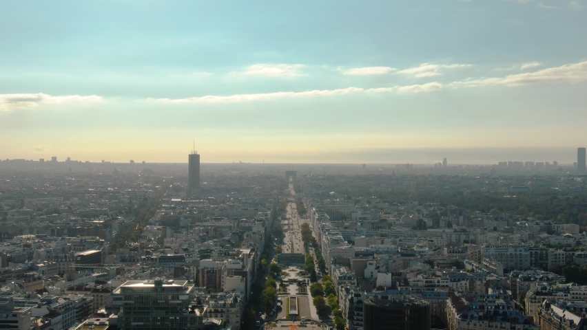 Panoramic aerial view of the paris skyline from above, showing city buildings and iconic landmarks under a bright sky