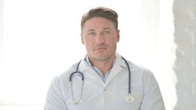 Portrait of Male Doctor Talking on Online Video Call