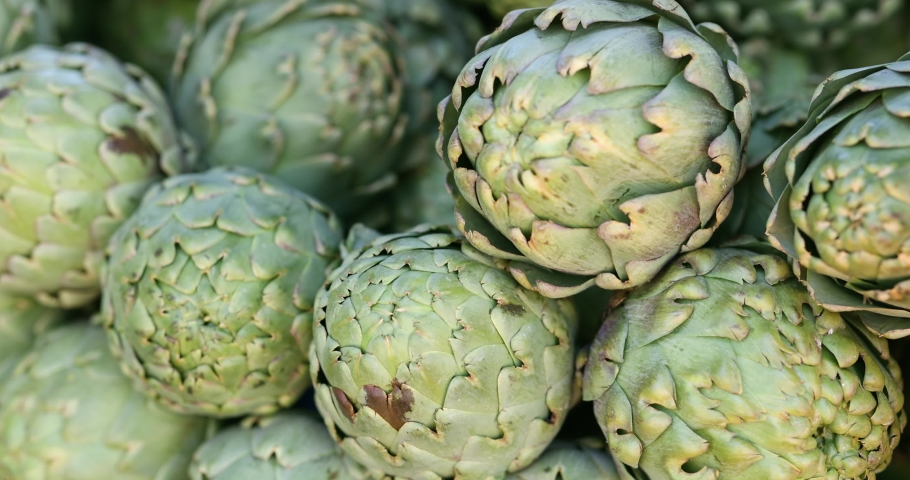 Fresh green artichoke on the counter of farmers market Royalty-Free Stock Footage #1090542691