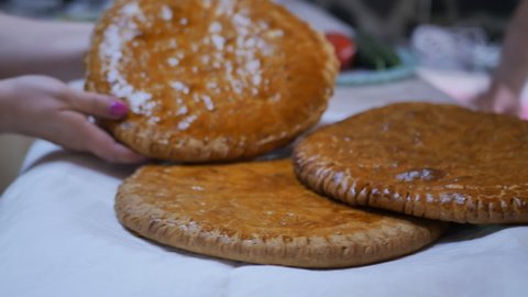 woman's hands hold fresh delicious Armenian gata golden color. The national bread product of the peoples of Armenia and Azerbaijan baked in tonir. Azeri kata