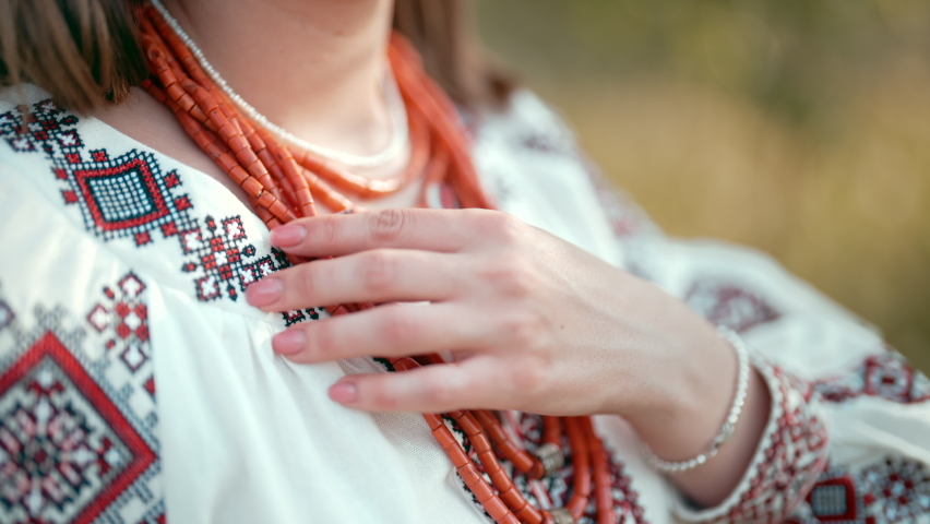 Ukrainian woman in embroidery vyshyvanka dress and ancient coral beads. Traditional antique jewelry necklace and costume of Ukraine.