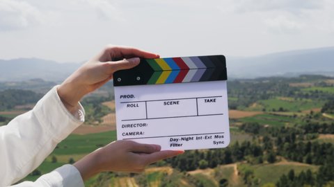 Clapperboard close-up. Movie clapper on nature background. Film production, cinematography concept. 