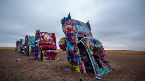Amarillo , Texas , United States - 05 18 2022: Time Lapse, Cadillac Ranch Art Installation, Painted Cars Under Dramatic Sky