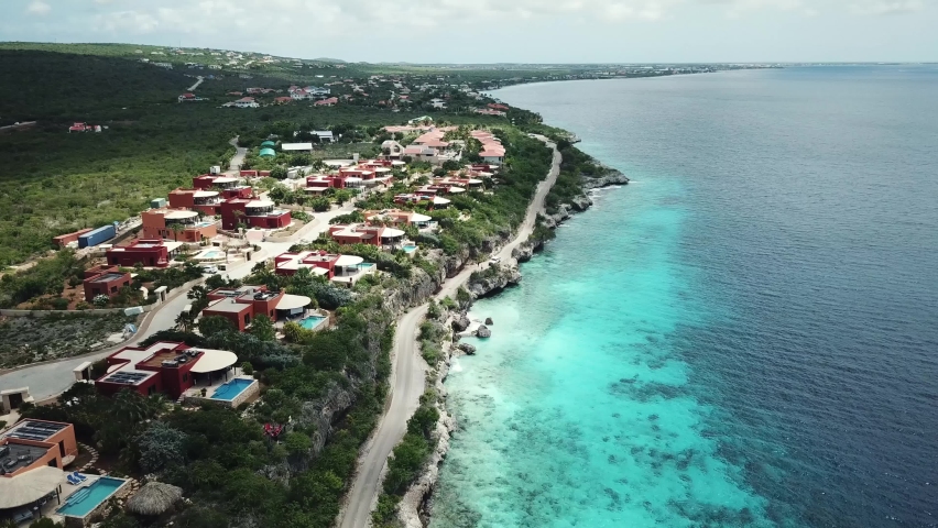 Orbital drone view of luxury villas on the coastline of Bonaire, Dutch Caribbean, in South America Royalty-Free Stock Footage #1090554405
