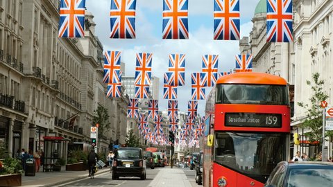 LONDON, circa 2022 - Regent Street in Central London, England, UK is seen decorated with Union Jack flags in preparation for the QUEEN PLATINUM JUBILEE celebration