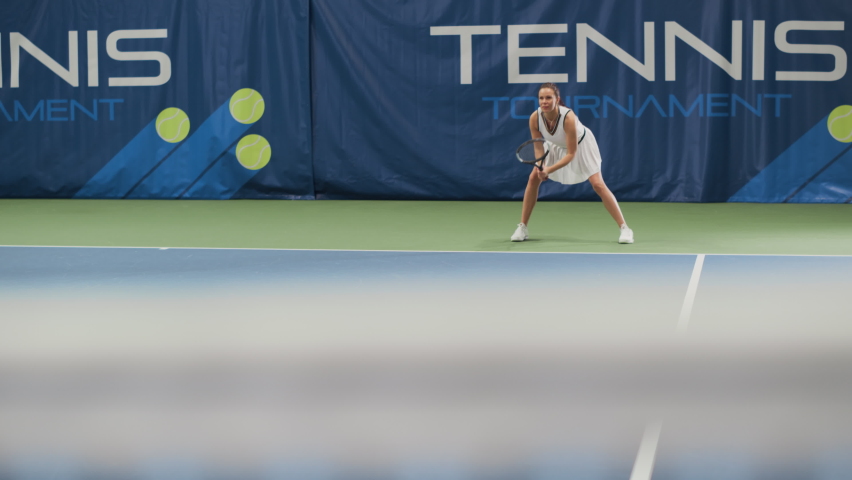 Female Tennis Player Hitting Ball with a Racquet During Championship Match. Professional Woman Athlete Receives and Lands Perfect Volley Shot. World Sports Tournament. Slow Motion Wide Shot Playback | Shutterstock HD Video #1090563819