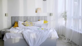 Excited young woman in colorful yellow pajamas and sleeping mask dances and sings having fun near bed in spacious hotel room in sunny morning - Powered by Shutterstock - Get 15% off with code: PIKWIZARD15