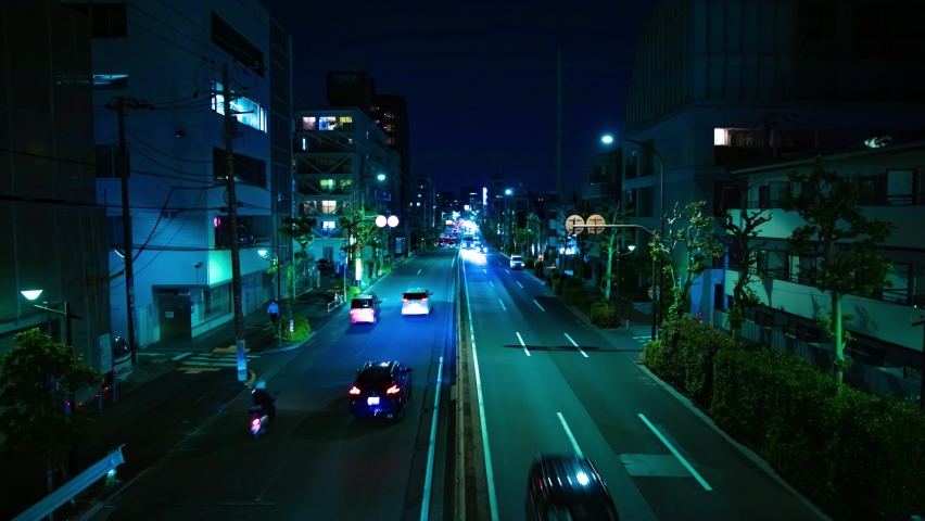 A night timelapse of the traffic jam at the urban street in Tokyo wide shot. High quality 4k footage. Setagaya district Tokyo Japan 05.10.2022 Here is a downtown street in Tokyo