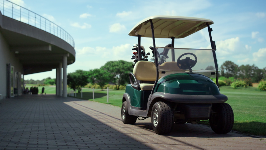 Golf cart stand field at country club. Empty car wait players on golfing game. Modern green buggy equipment in sport equipment putters in morning summer sunlight. Sport active hobby no people concept. Royalty-Free Stock Footage #1090578311