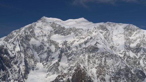 Aerial view of a rocky snow-covered mountain, the tallest mountain in Canada, Mount Logan