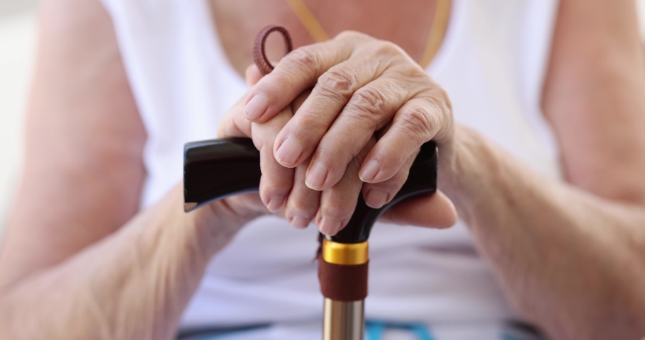 Sick elderly woman holding cane closeup 4k movie slow motion | Shutterstock HD Video #1090579829